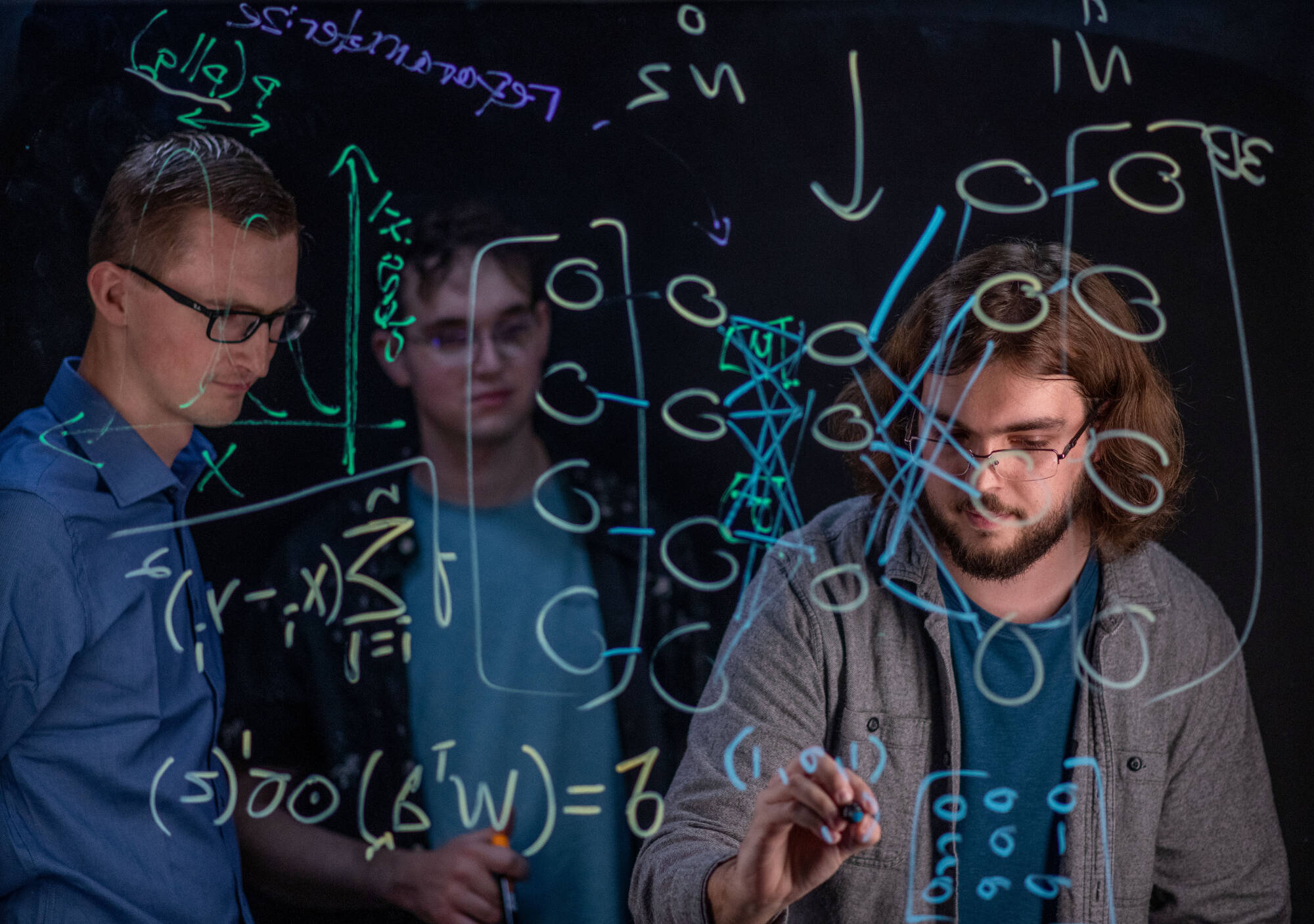 Zachary DeBruine, left, is an assistant professor of computing. Students, from left, are Seth Wolfgang and Skylar Ruiter(Photo releases on file)